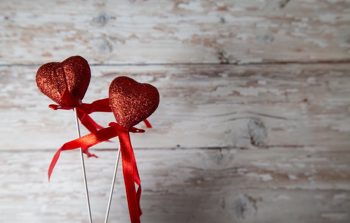 Wooden hearts, one red heart on the heart background. Stock Photo