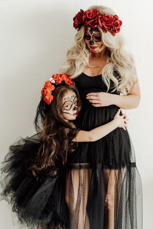 Free A Mother and Daughter in Black Dresses and Creepy Art Makeup Stock Photo