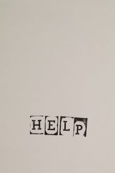 A minimalist design with the word 'Help' on a gray background for art lovers.