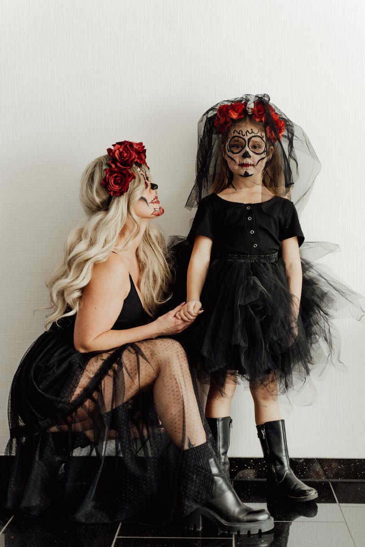 Mother And Daughter Wearing Halloween Costumes With Makeup