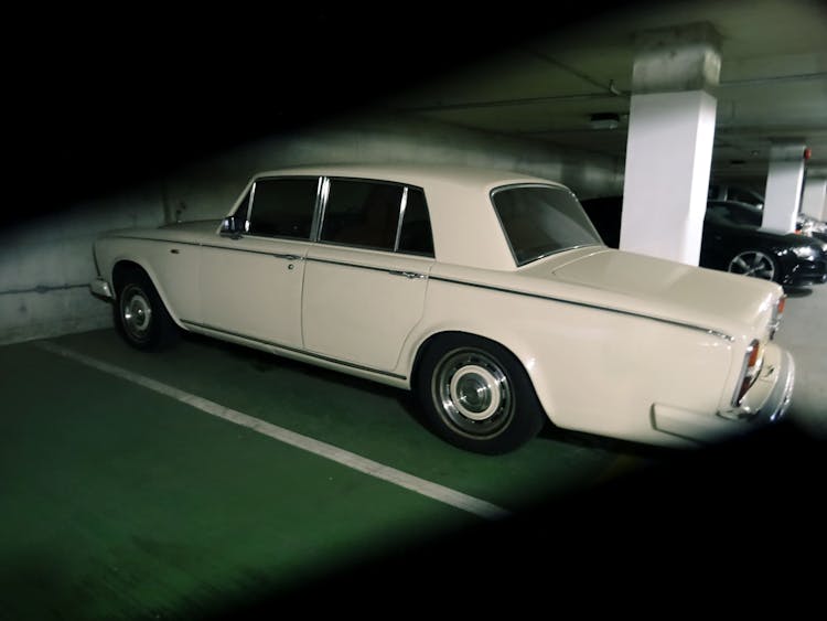 Photography Of Vintage Car Parked On A Parking Lot