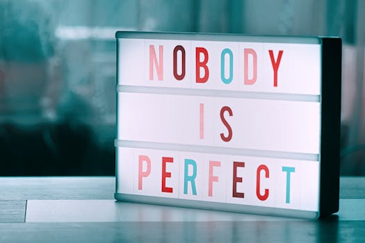 Close-up of a light box displaying 'Nobody is Perfect' inspiring self-acceptance.