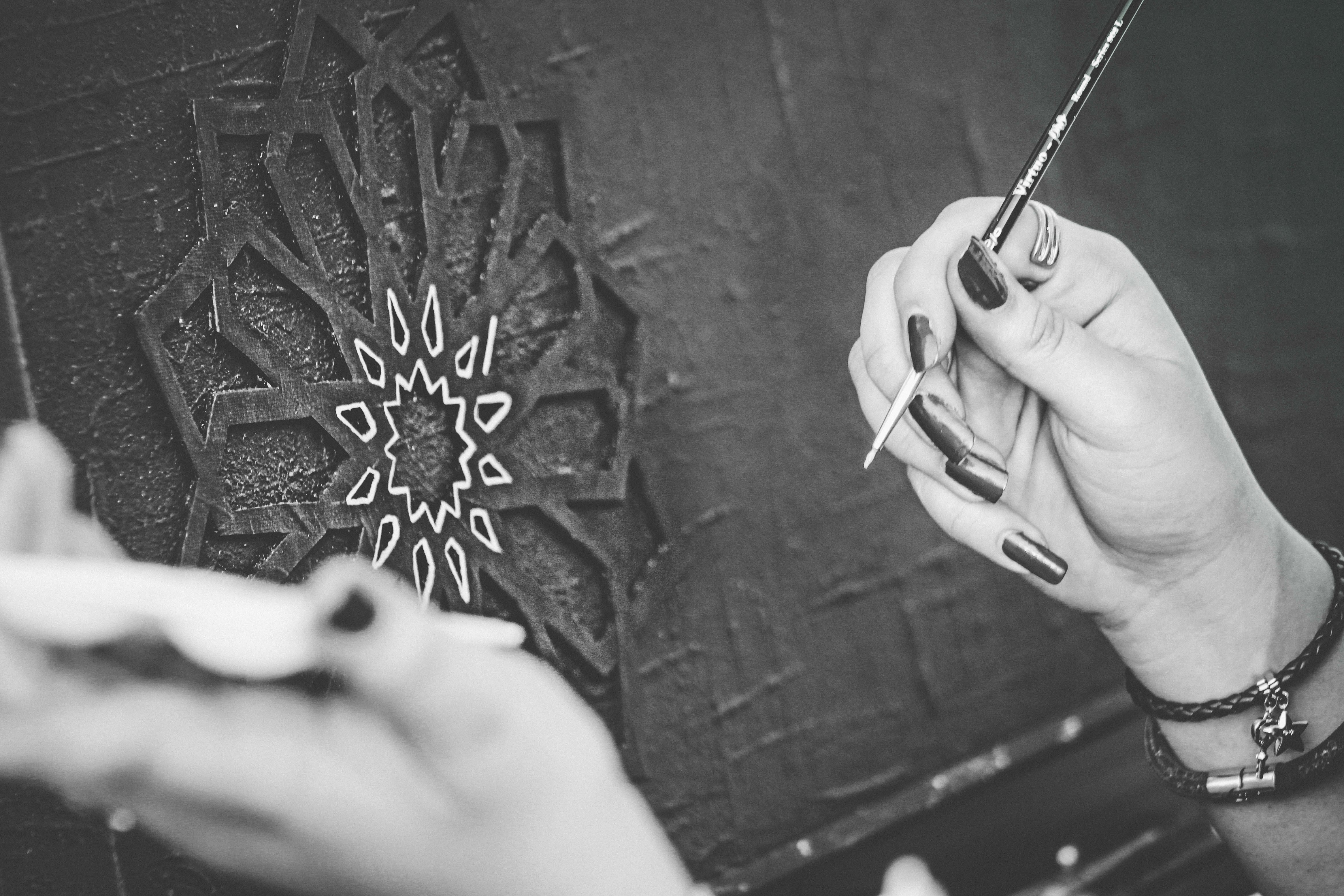 Black and White Photo of Hands Holding a Paintbrush · Free Stock Photo