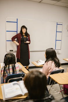A teacher engages students in a classroom discussion on bullying prevention.