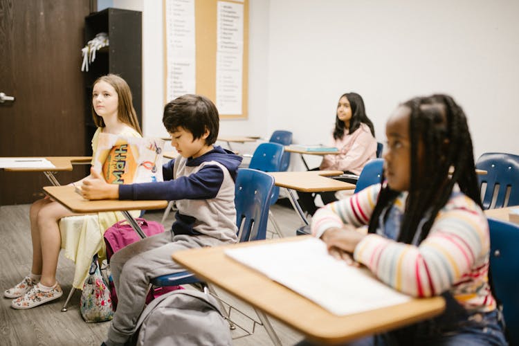 Students Sitting Inside The Classroom