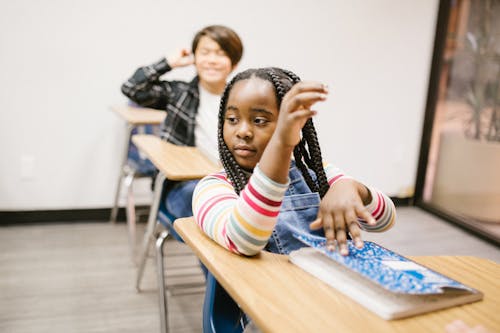 Girl Sitting on Her Desk