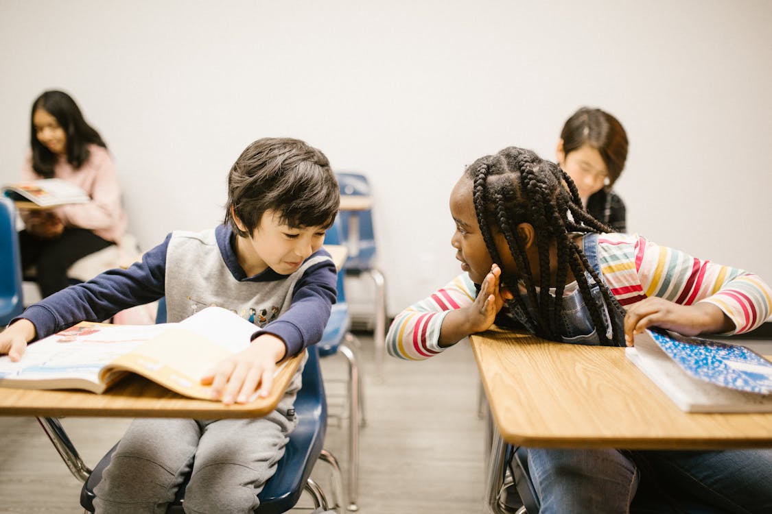 Two Students Gossiping With One Another