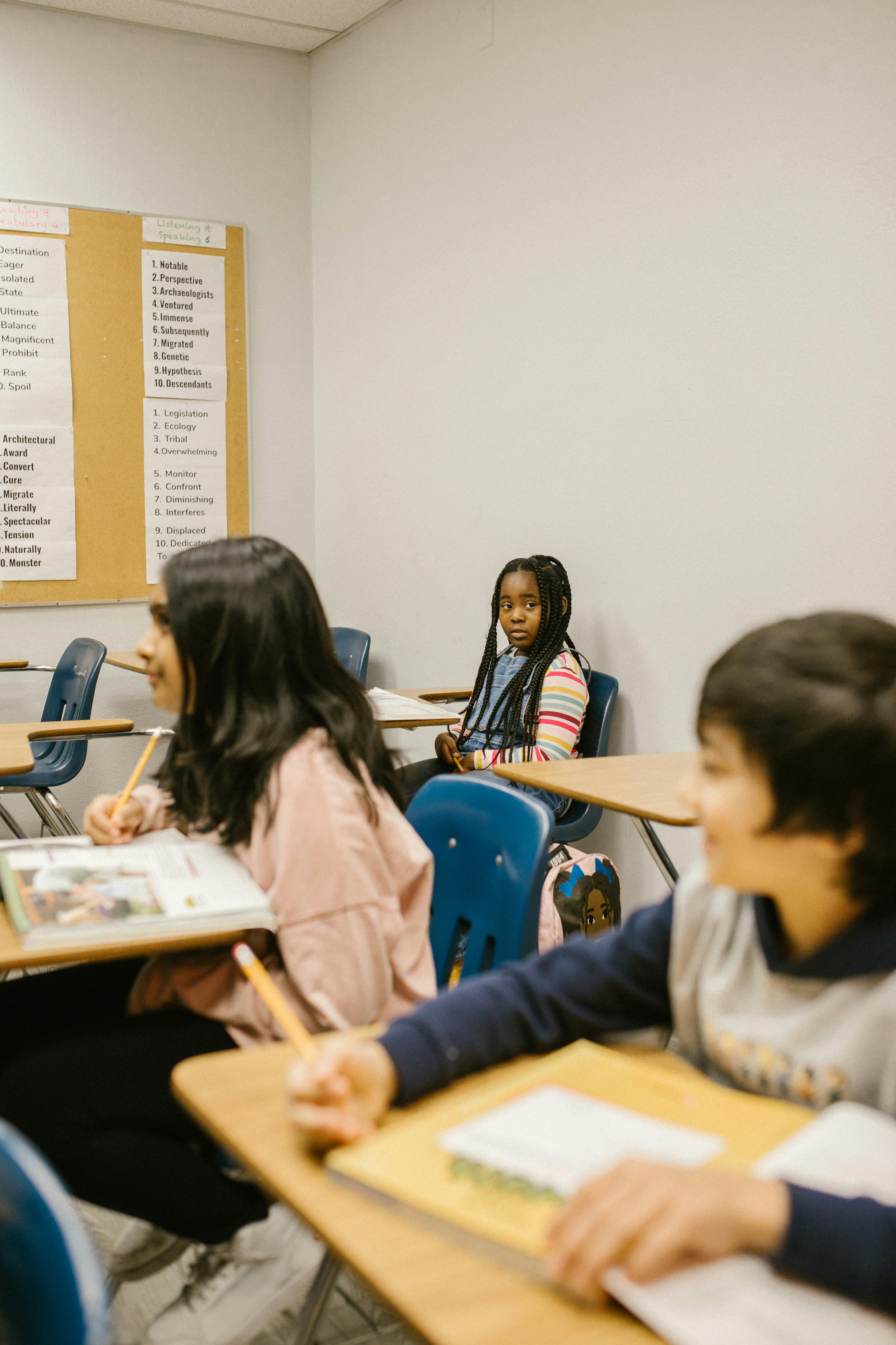 a girl sitting lonely by herself in the classroom