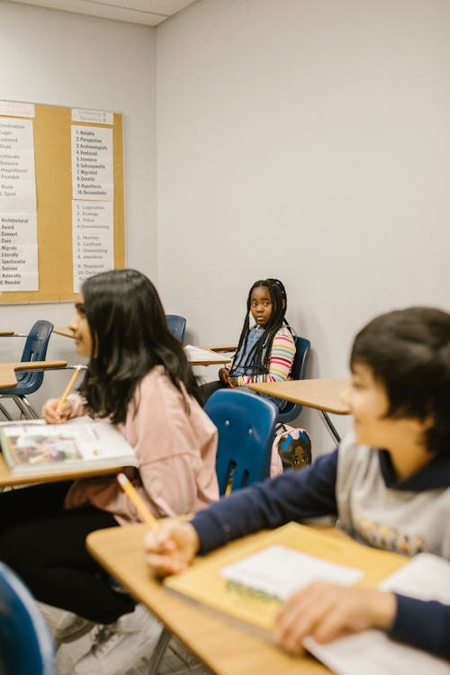 A Girl Sitting Lonely by Herself in the Classroom