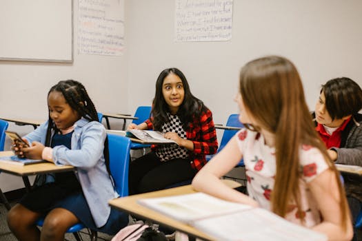 A group of diverse students engaged in conversation during a classroom session, fostering a learning environment.