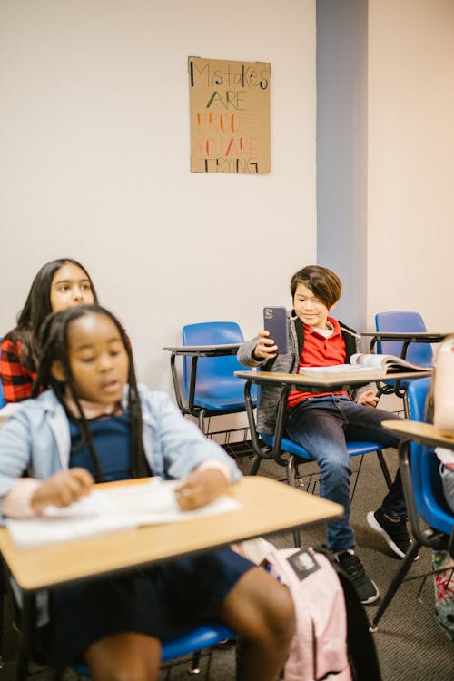 Boy Taking Photo of His Classmate