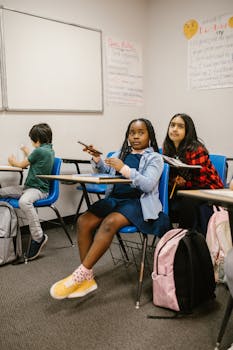 Diverse group of children in a classroom focusing on a lesson together.
