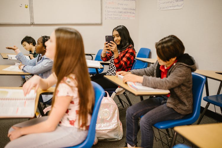 Girl Taking Photo Of Her Classmate