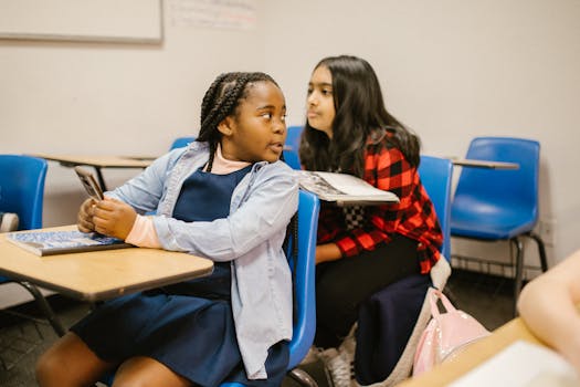 Two students interacting in a classroom, emphasizing diversity and education themes.
