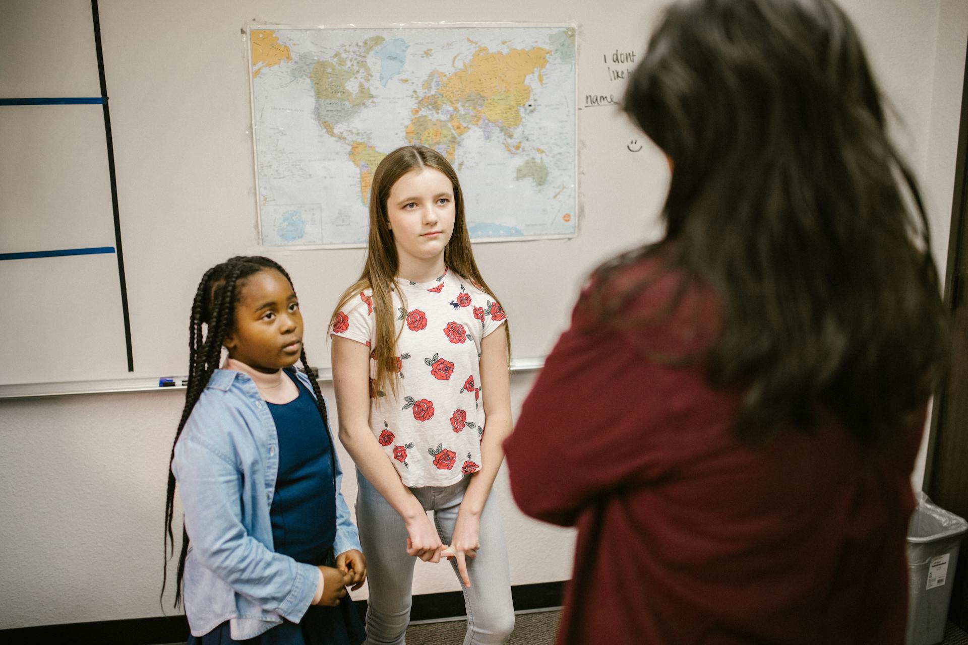 Two Girls Getting Scolded by Their Teacher