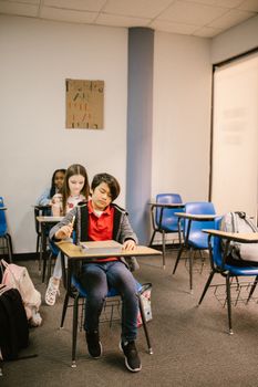 Children seated in a classroom environment with an emphasis on education and learning.
