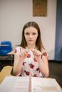 Girl Sitting on Her Desk Looking Angry