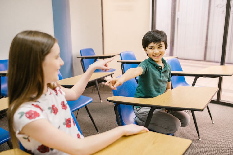 Two Kids Pointing At Each Other