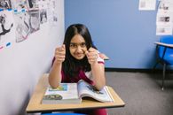 Girl Sitting on Her Desk Looking Angry
