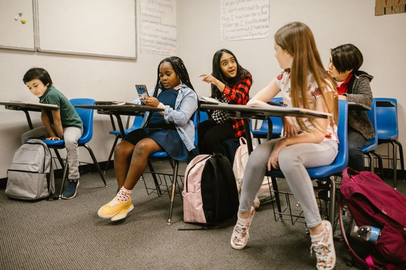 Parent helping teenager manage ADHD symptoms and school work
