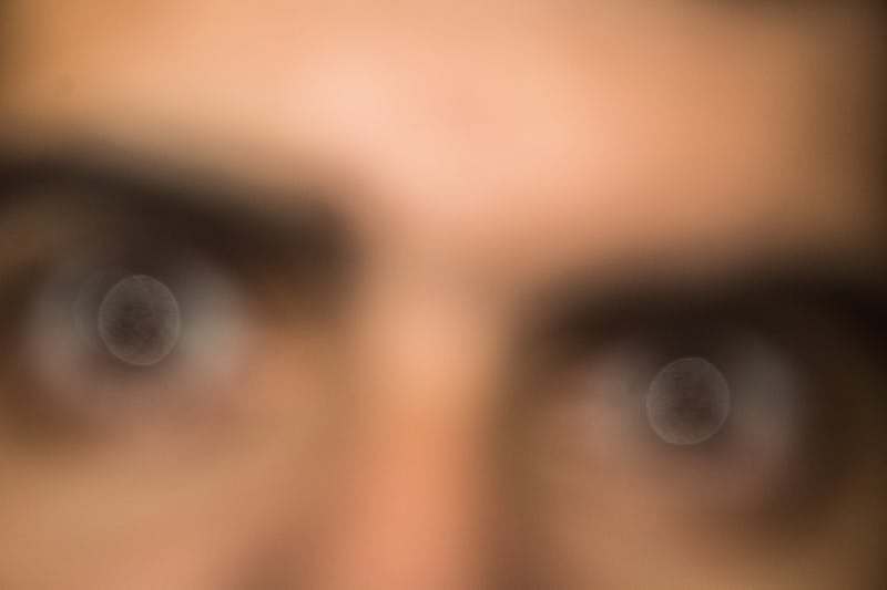 Person engaged in creative journaling with watercolors and artistic materials on a wooden table