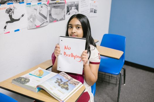 Girl Showing a Message Written in a Notebook