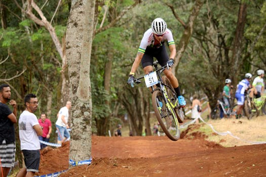 Professional mountain biker speeds on forest trail during a thrilling race event.