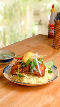 Delicious gourmet chicken meal on rice with fresh vegetables, perfect for lunch.