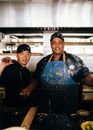 A Man Holding a Rolling Pin beside Another Man Wearing an Apron