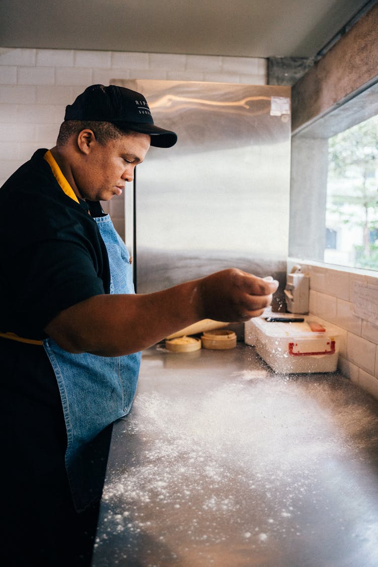 A Worker In A Pizza Parlor