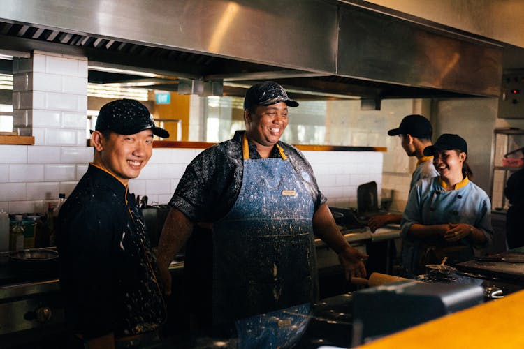 Workers Inside The Kitchen Of A Restaurant