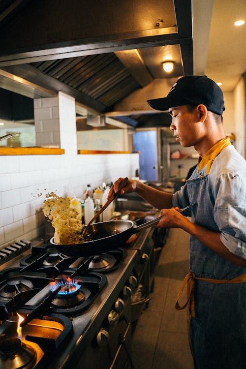 Free A Chef Cooking Fried Rice in a Wok Stock Photo
