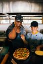 A Man and a Woman Preparing a Pizza