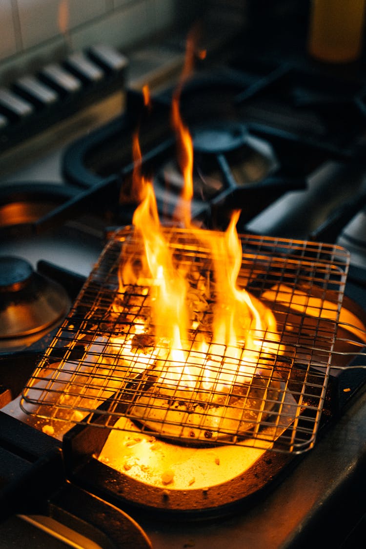 Cooking On Grille With The Stove Flame