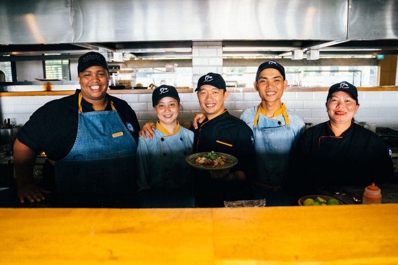 Group of chefs together in a restaurant kitchen