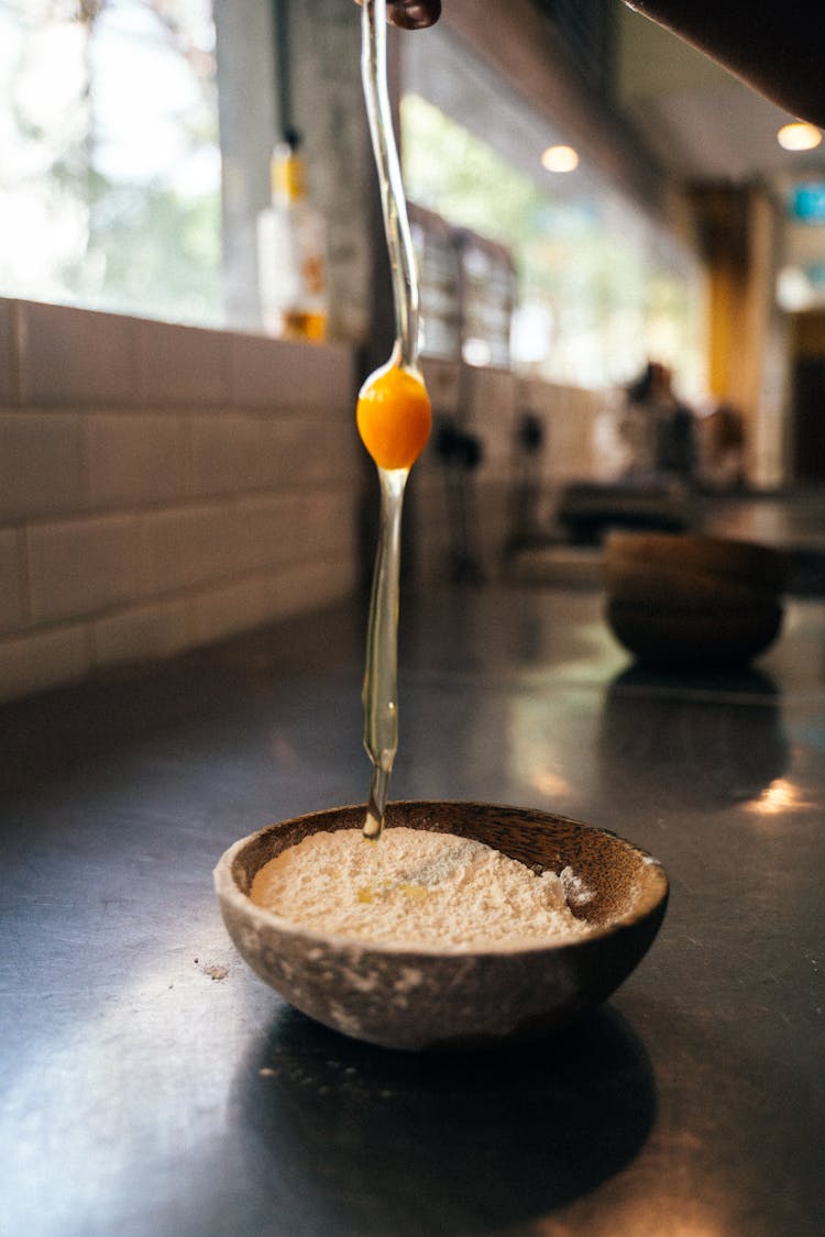 An Egg Dropping On The Flour