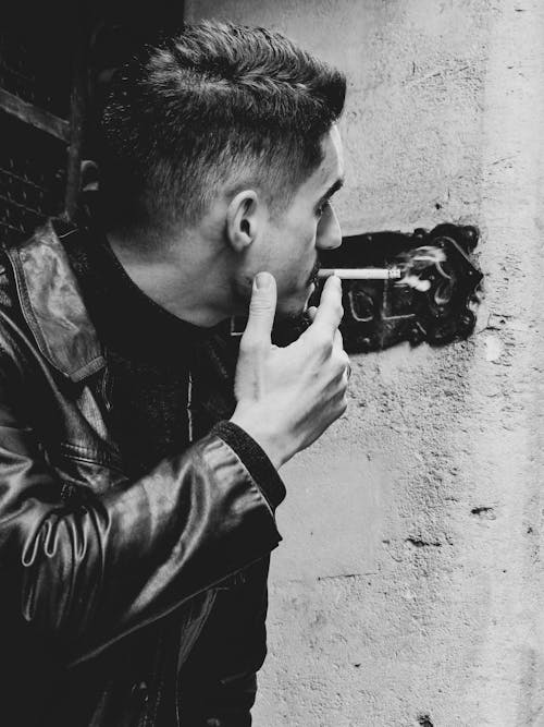 Free stock photo of black and white, black leather jacket, cigarette