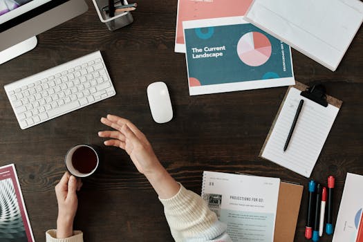 A top view of a workspace with documents, keyboard, and coffee, ideal for business and productivity themes.