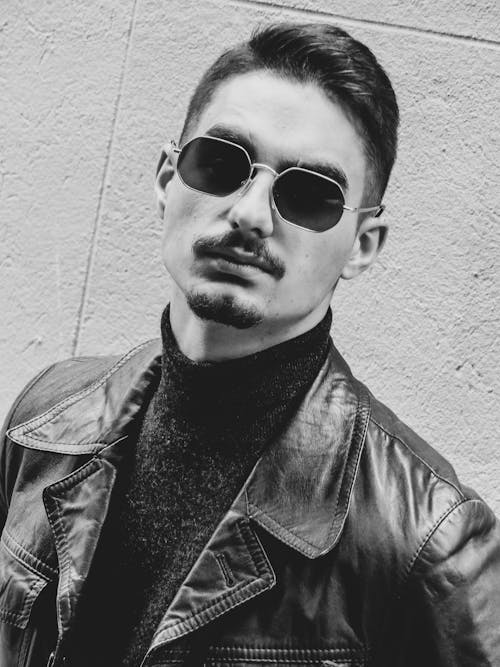 A Man Wearing Sunglasses and Black Leather Jacket 