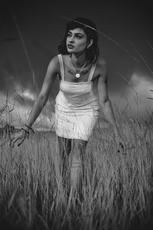 Stylish woman in grassy meadow