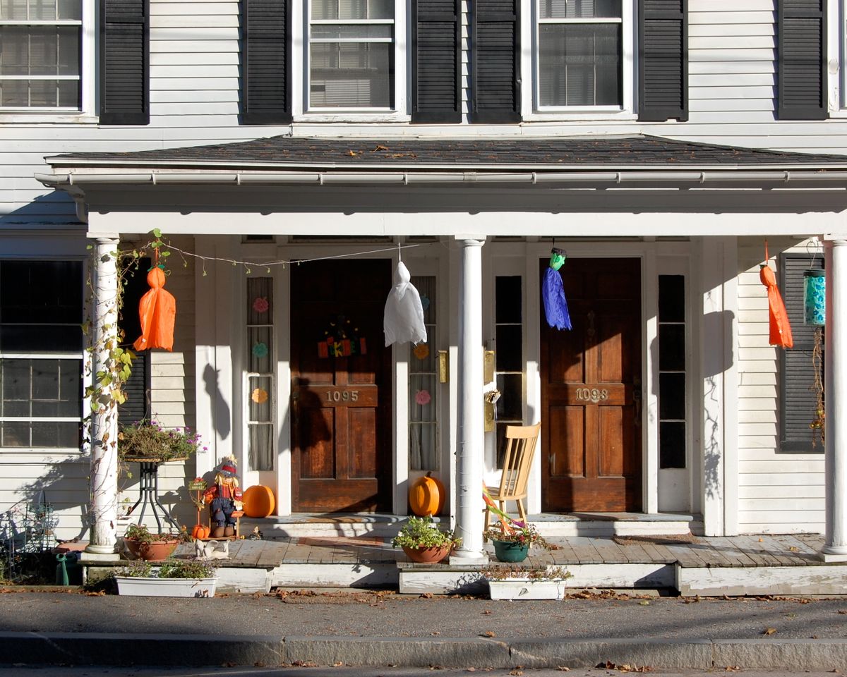 Cozy porch decorated with festive Halloween decorations and vibrant colors.
