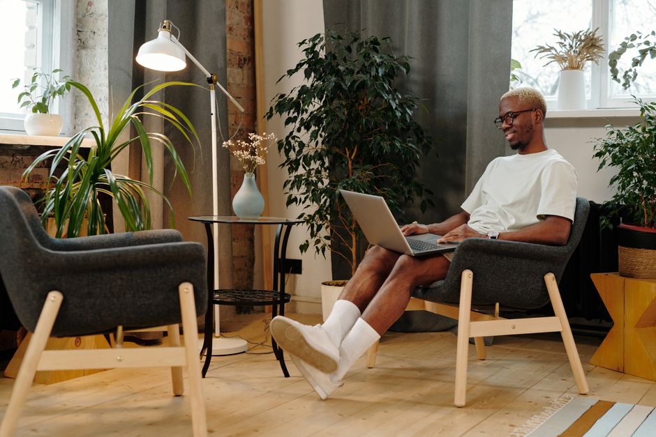 Unlock the Secret to Posture-Friendly Living with Hanamori's Japanese-Inspired, Space-Saving Furniture Solutions A person sitting comfortably on a low-seated Japanese sofa with a straight back, demonstrating good posture
