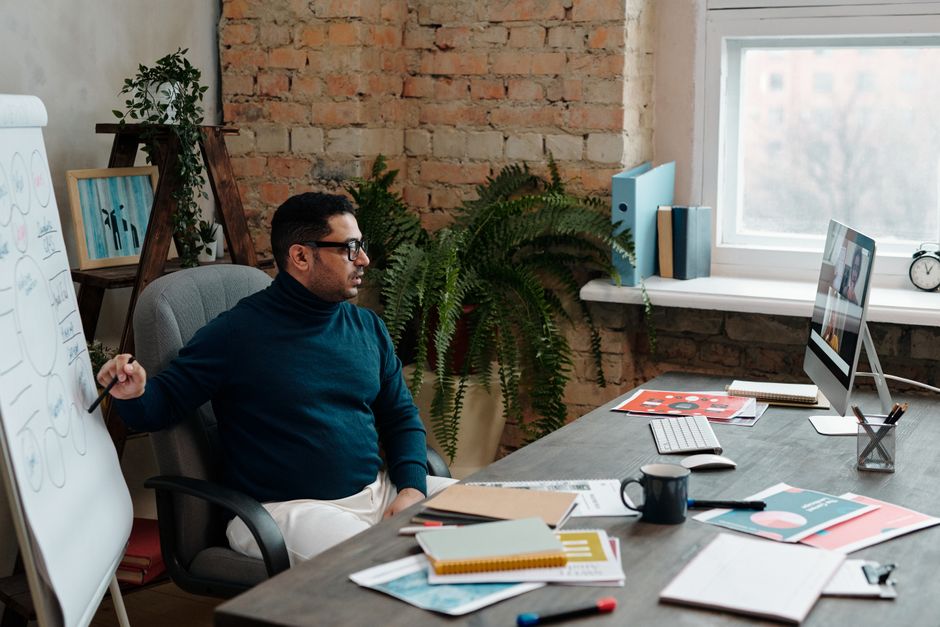 Businessman in a cozy office setting conducting a video call. Professional work environment with modern decor. Businessman in a cozy office setting conducting a video call. Professional work environment with modern decor.