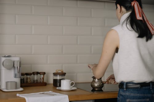 Backside of a Woman Making Coffee