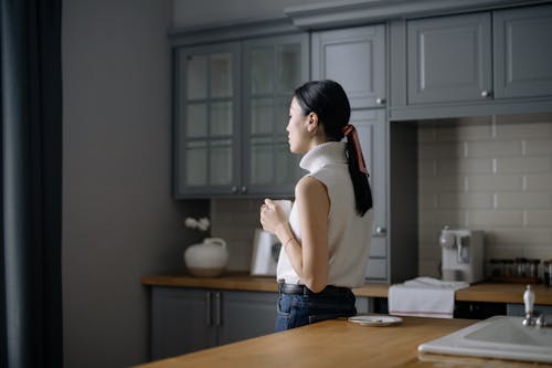 A Woman Having Coffee in the Kitchen