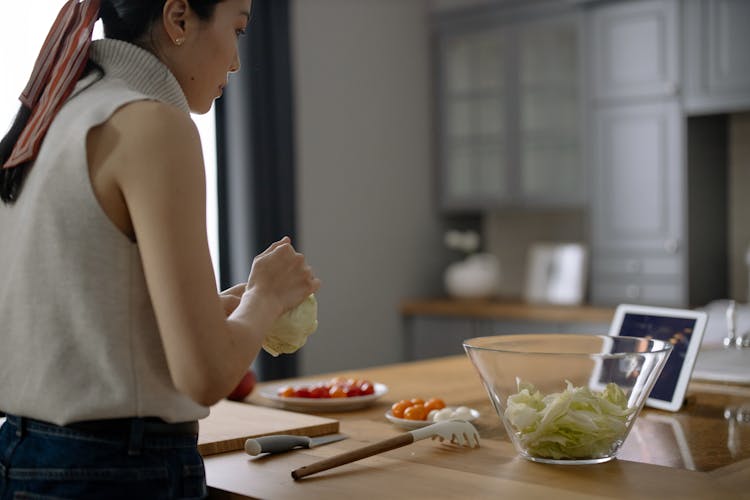 Woman Cooking With Tablet On Table In Kitchen 