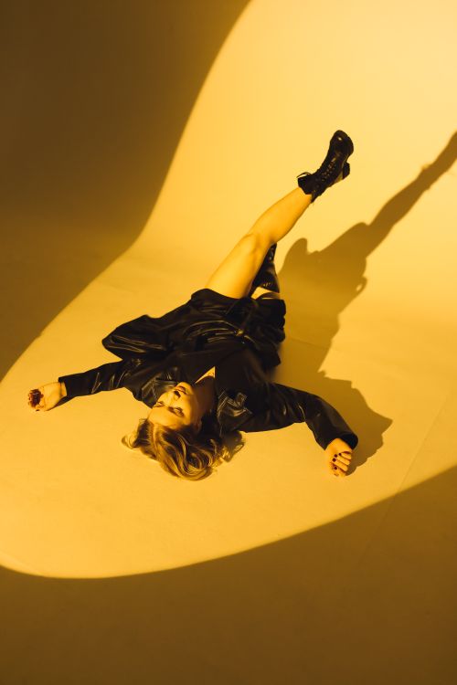 Free Stylish woman posing in black leather under dramatic lighting indoors. Stock Photo
