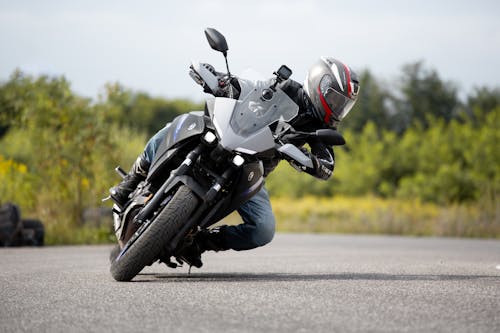 A Person Riding a Motorcycle Doing Banking 