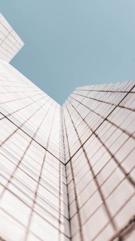 Upward view of a skyscraper emphasizing modern design and unique perspective.