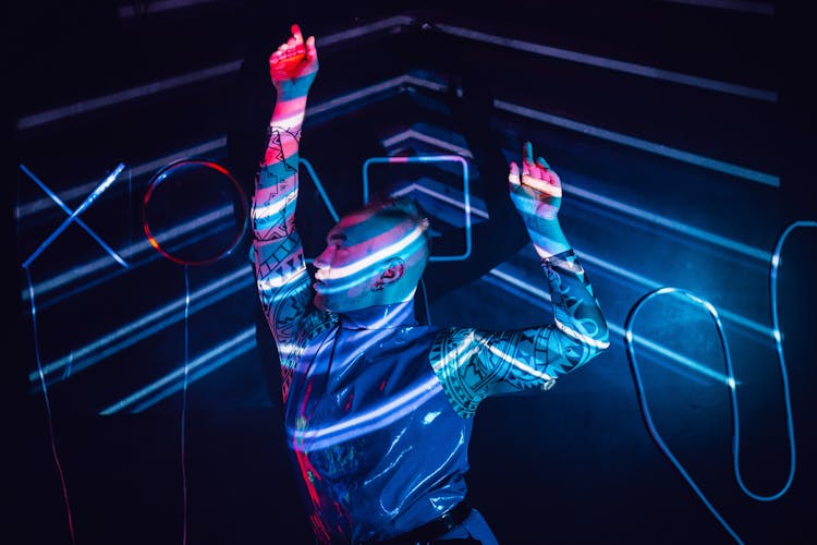 A Man Dancing With Neon Lights 